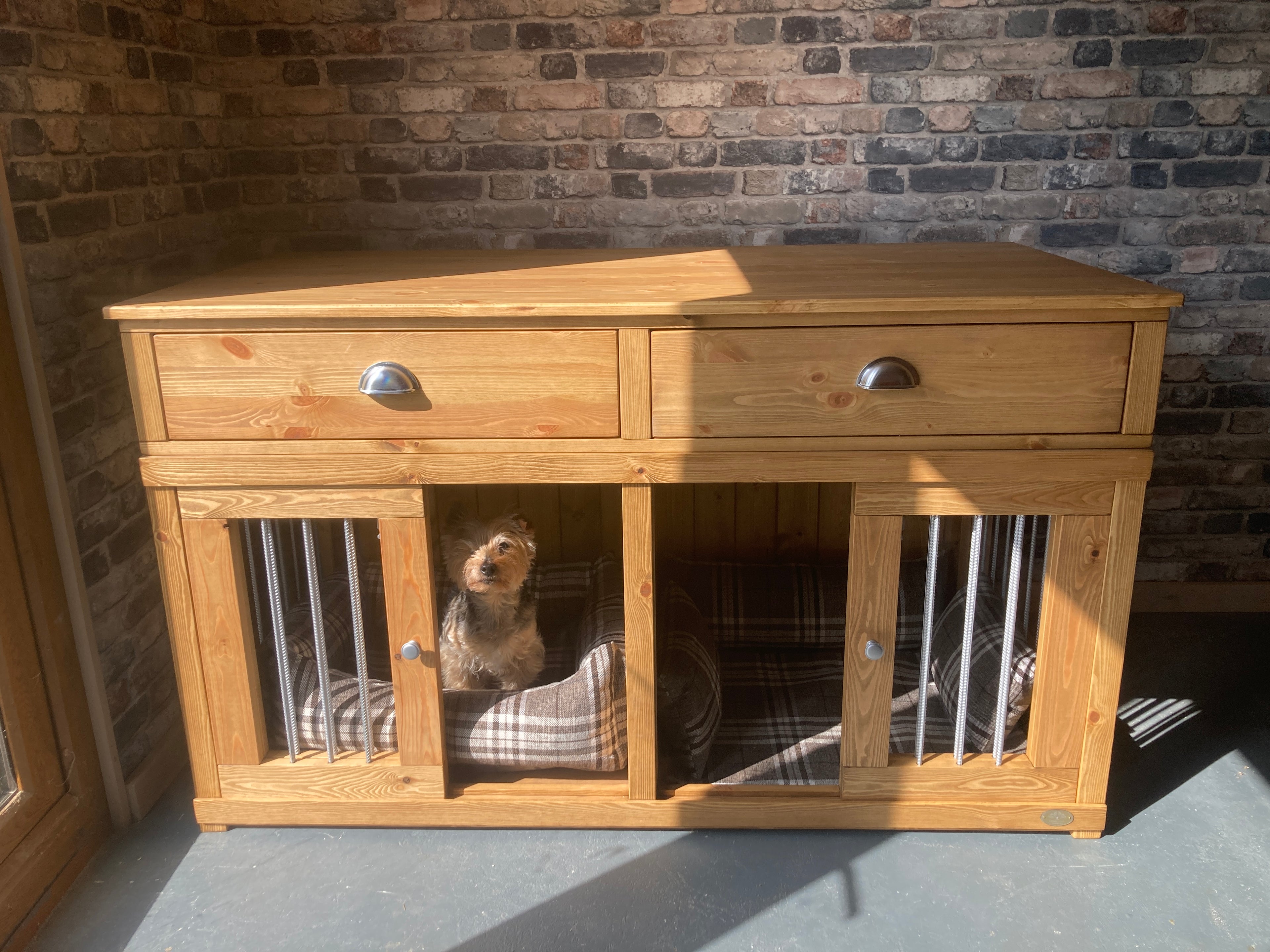Double wooden indoor dog crate furniture with drawers in natural pine, two-bed design for small dogs.