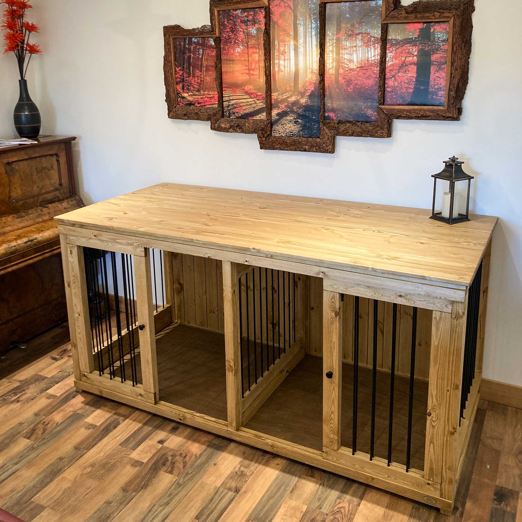 Handcrafted double wooden dog crate furniture with three compartments and black metal bars in a living room.