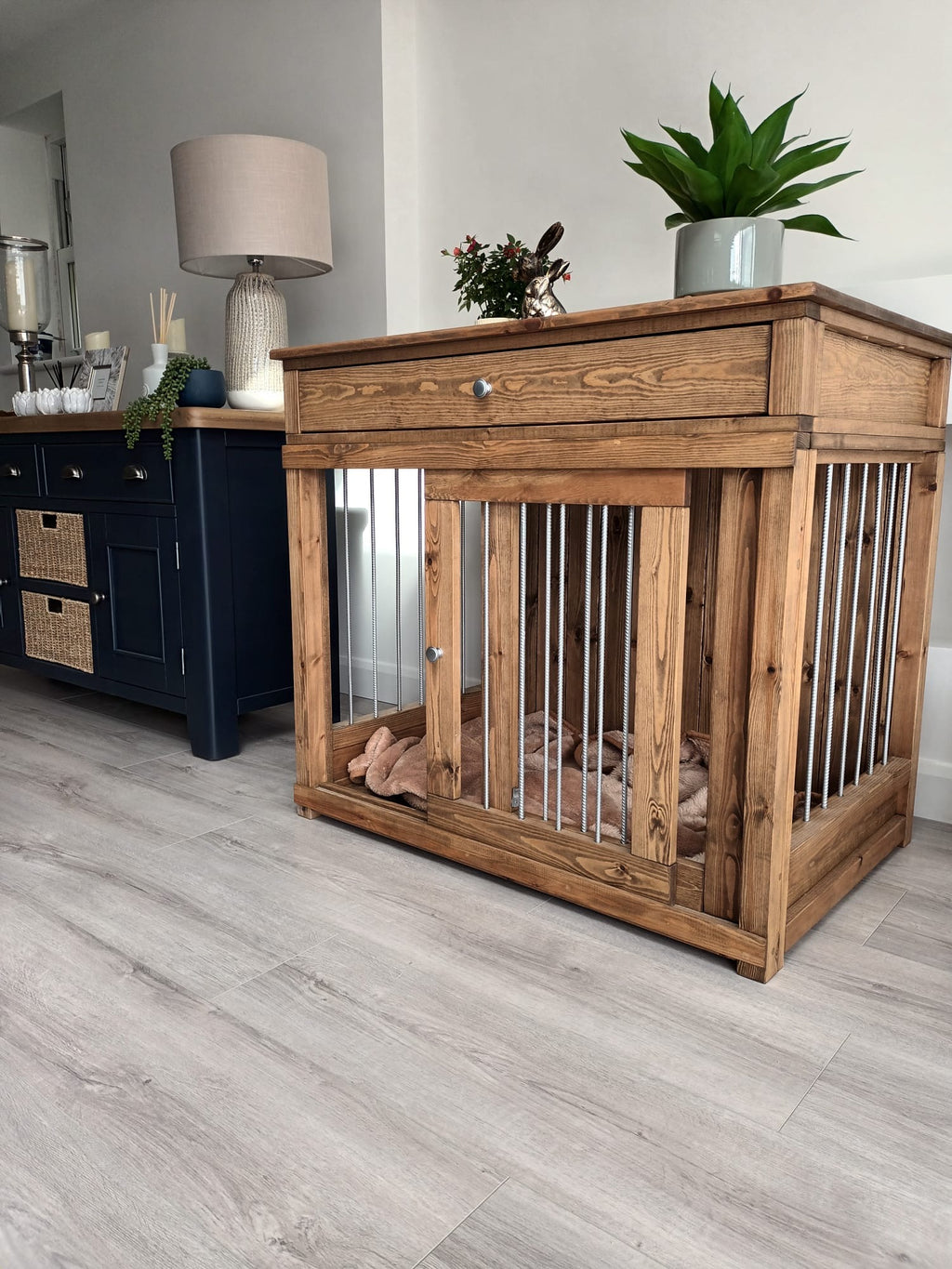 Single wooden dog crate furniture with metal bars and top drawer, styled in a modern hallway interior.
